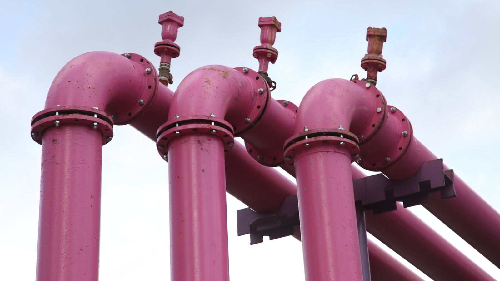 A bundle of interconnected industrial pipes branching at junction points — a fitting metaphor for n8n's node-based workflow graph.